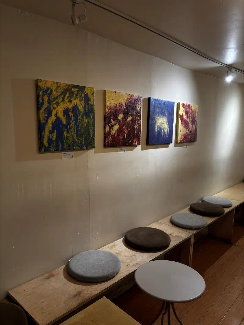 Four works by Andrada on display at Carbonic Coffee, a café at 37 Baldwin Street, Toronto. His work has hung there since 2026.