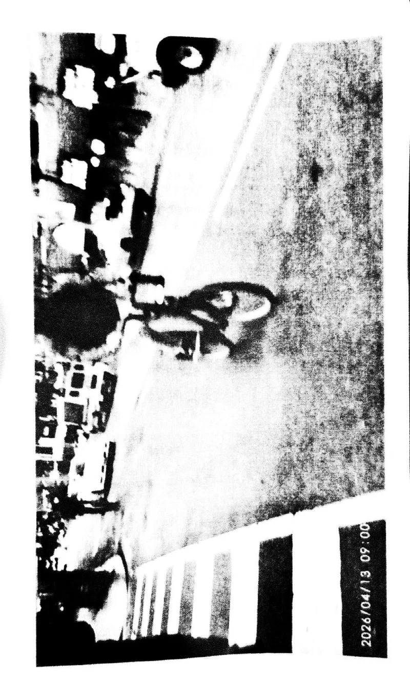 A cyclist crossing a street, 13 April 2026.