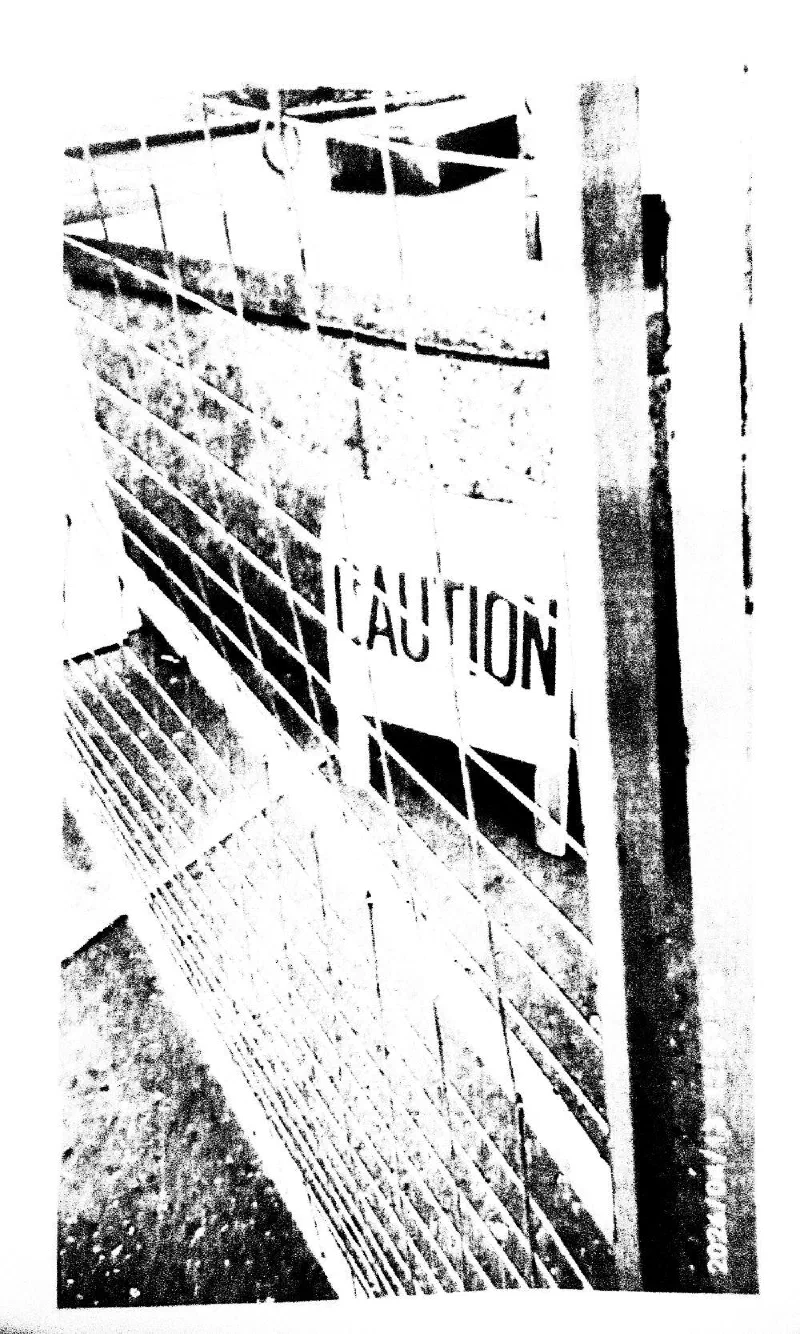 A construction fence with a CAUTION sign.