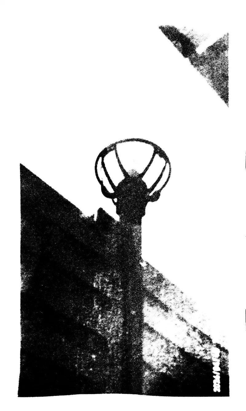 A street lamp against the corner of a building, seen from below.