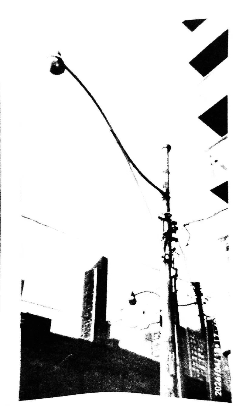 Street lamps and utility poles against the sky.