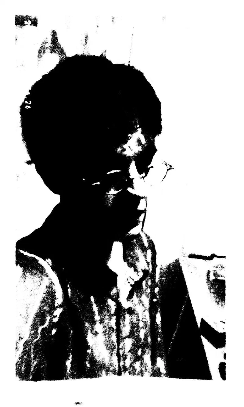 A close portrait of a person in glasses, in hard black and white.