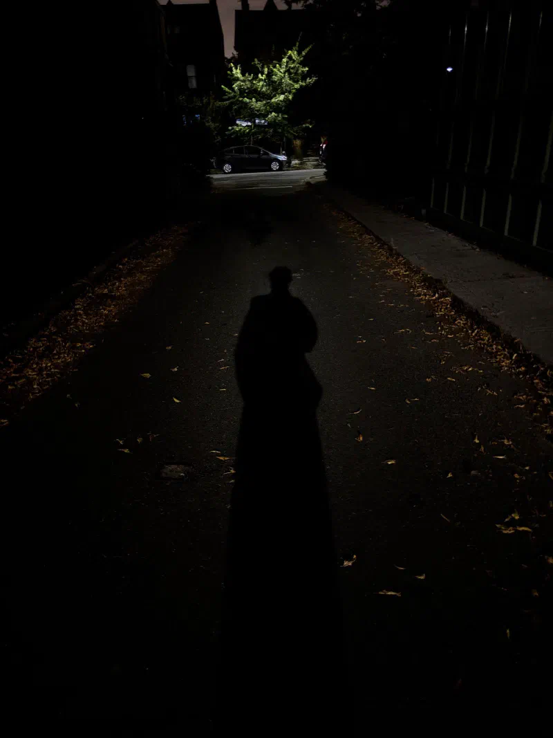 Andrada's own shadow on a dark lane at night, September 2026.