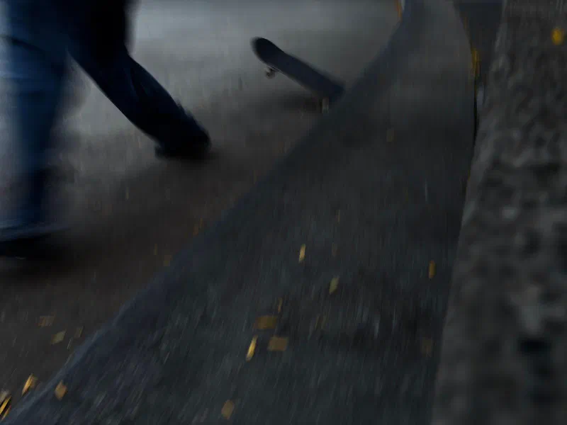 A skateboarder in motion, blurred, September 2026.