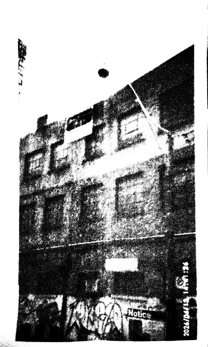 A brick building with graffiti at street level, 15 April 2026.