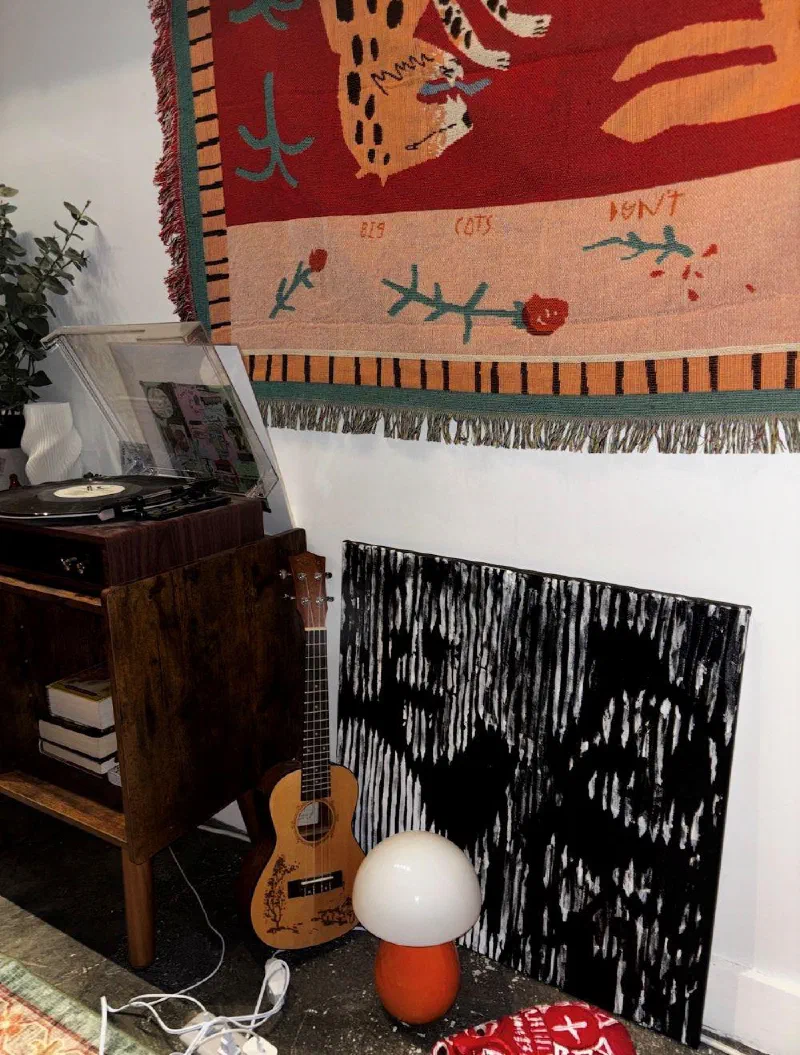 Subjects N.3 & 4 (2026) leaning against the wall of the third studio, beside a record player.