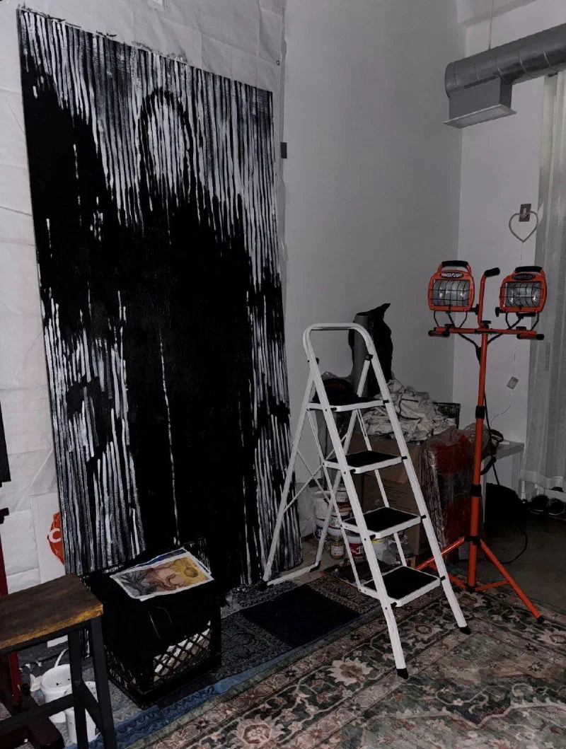 Untitled (Death), 2025, against the wall of the third studio, with a stepladder and work lights.