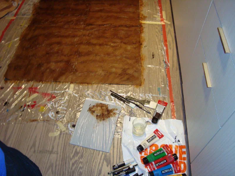 A painting in progress on the plastic-covered floor of the first studio, 2024.