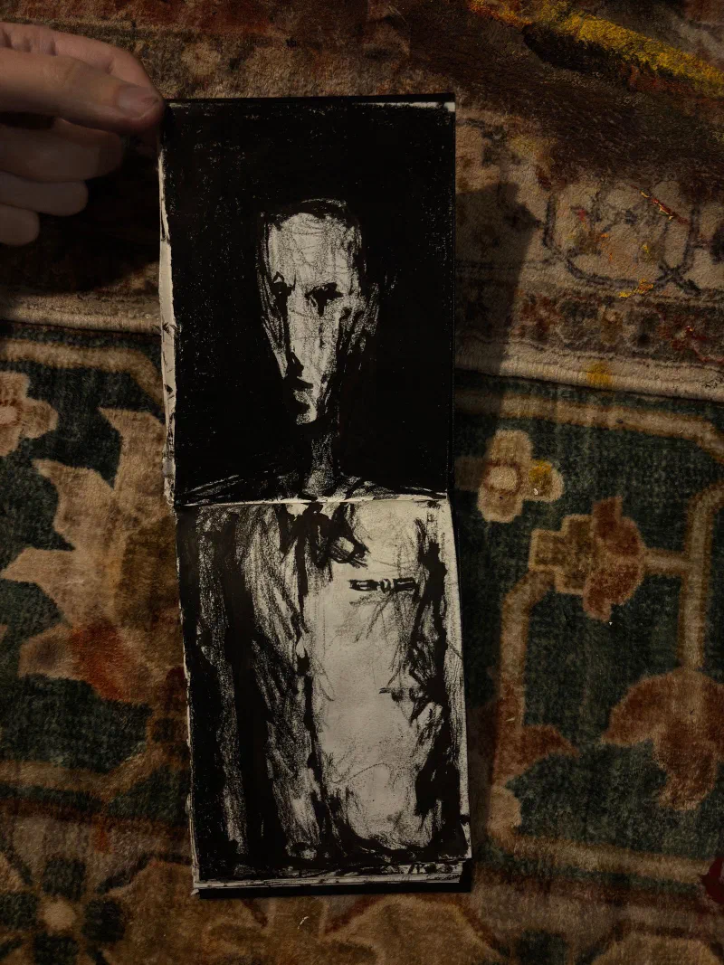 A sketchbook spread: a gaunt face and torso on a black ground, August 2026.