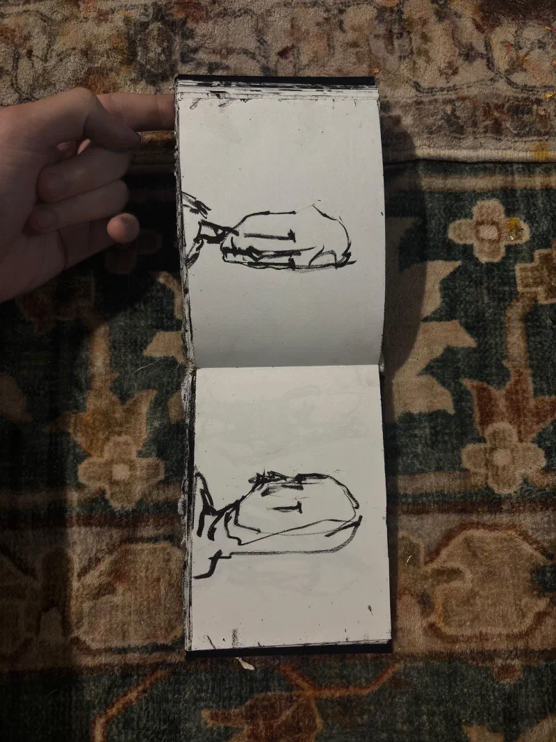A sketchbook spread: two heads lying sideways, August 2026.