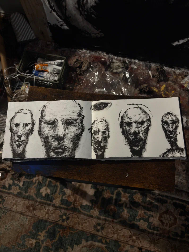 A sketchbook spread of five faces in ink, September 2026.
