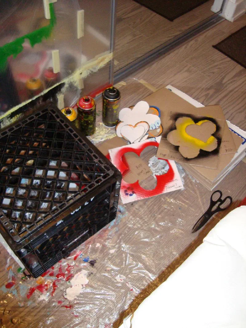 Stencils and spray cans from the first heart-flower test, first studio, 2024.